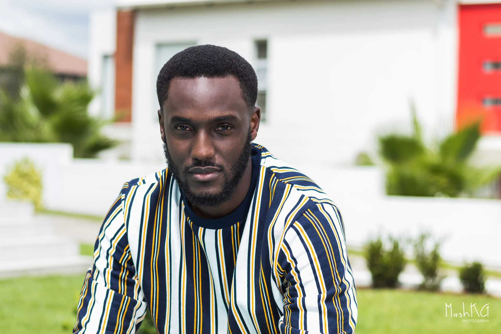 Adrian Silas photographed outdoors in a striped shirt