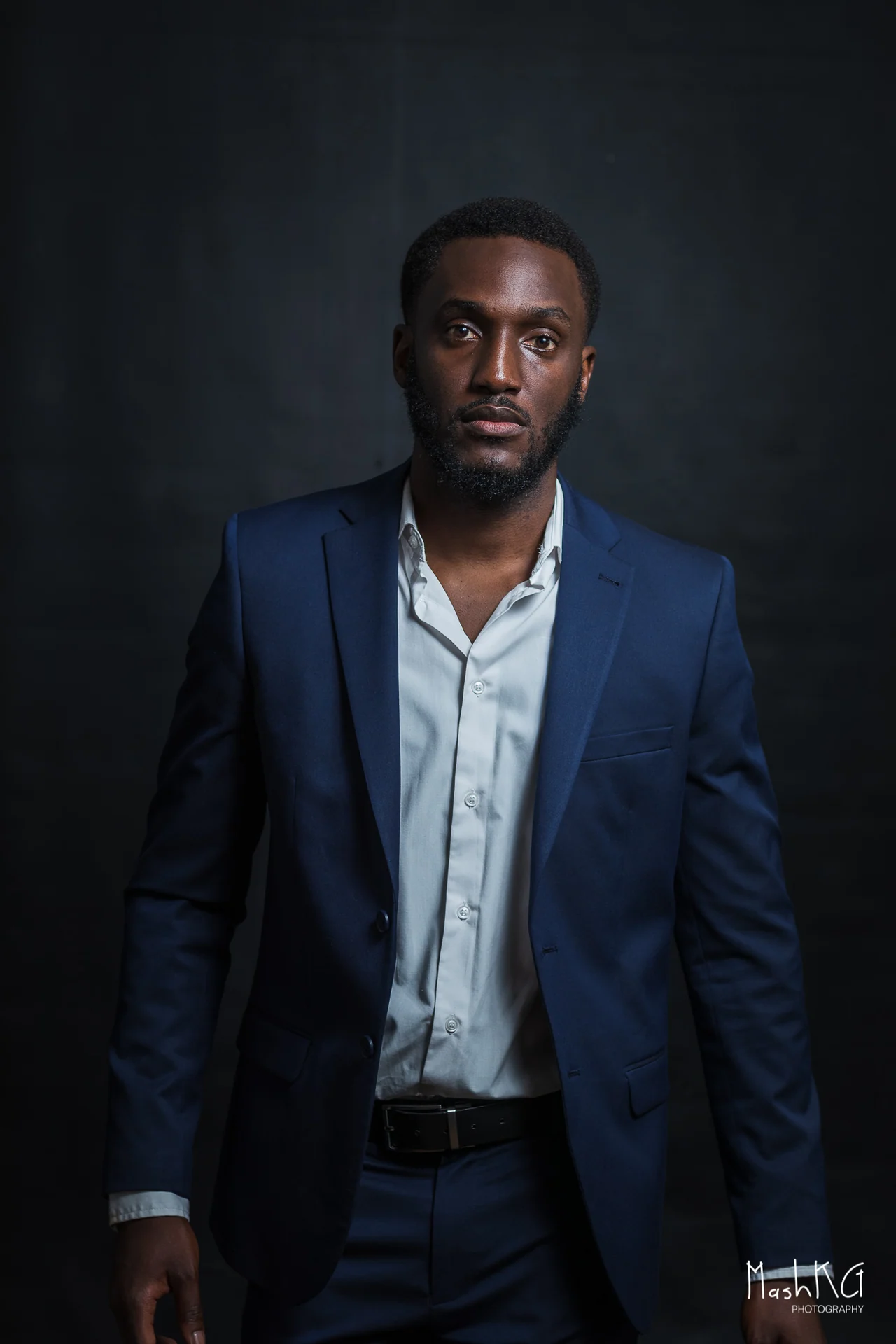 Adrian Silas in a navy suit, studio portrait