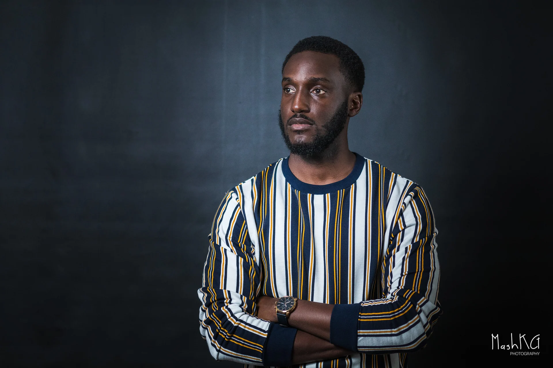 Adrian Silas, music producer and composer, in a striped shirt