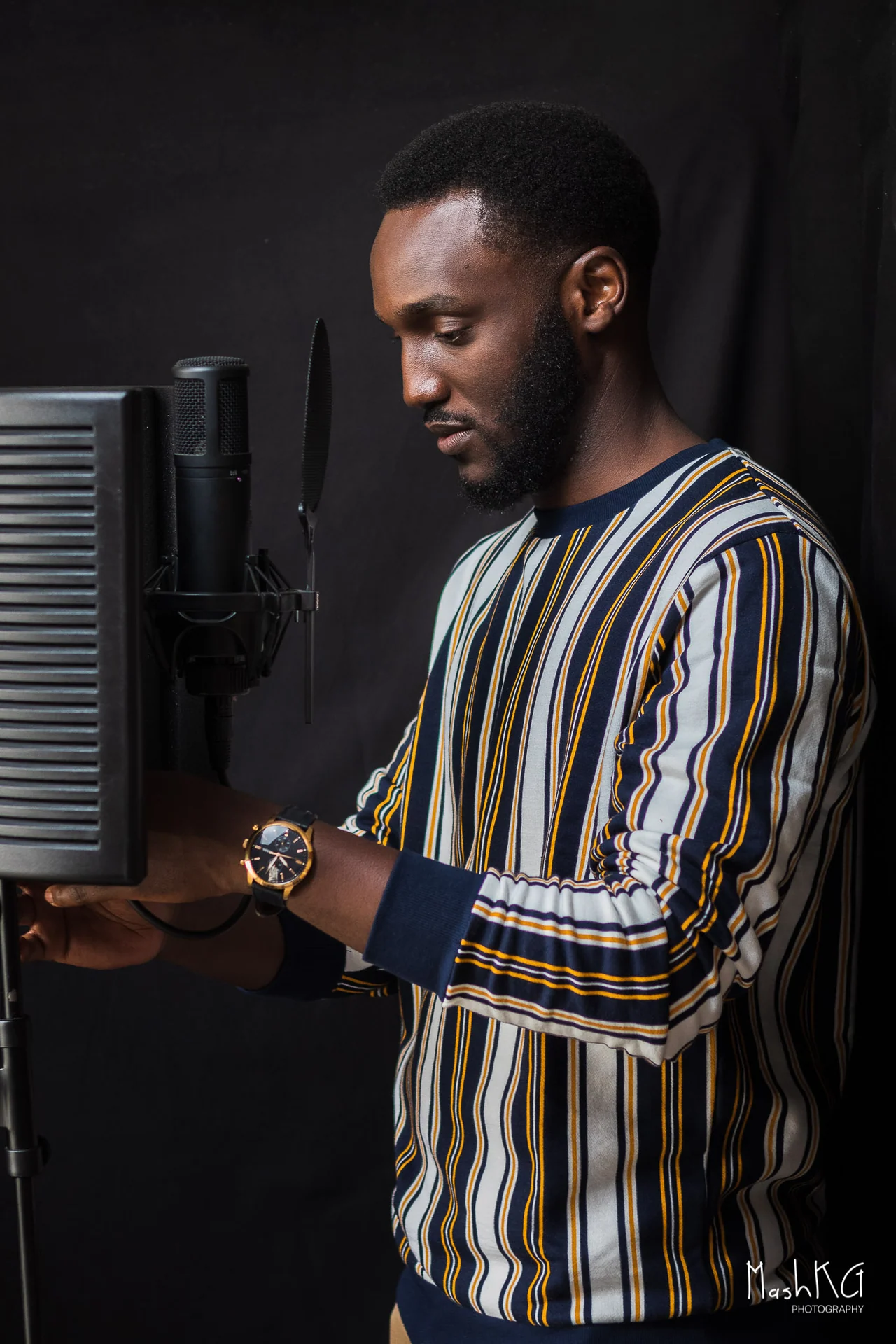 Adrian Silas preparing to record at his studio microphone